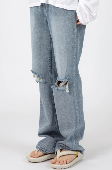 Blue-washed knee destroyed jeans