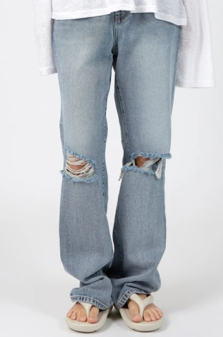 Blue-washed knee destroyed jeans