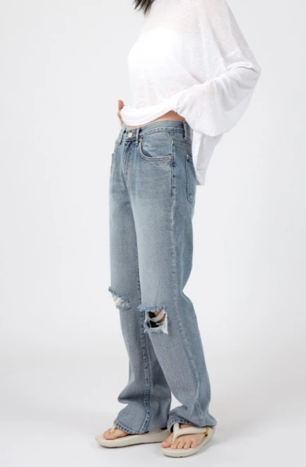 Blue-washed knee destroyed jeans